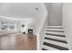 Bright living room features hardwood floors, fireplace, and stairway to the second floor at 1042 Planters Pl, Mount Pleasant, SC 29464