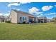Well-maintained backyard with a spacious lawn, screened porch, and manicured landscaping at 106 Sea Lavender Ln, Summerville, SC 29486