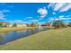 A lush backyard with a tranquil water view and fountain feature at 106 Sea Lavender Ln, Summerville, SC 29486