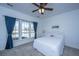 Serene bedroom featuring neutral carpet, ceiling fan, and a large window with backyard views at 106 Sea Lavender Ln, Summerville, SC 29486