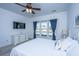 Comfortable bedroom with a window overlooking the water, ceiling fan, and white furniture at 106 Sea Lavender Ln, Summerville, SC 29486