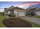 Charming home exterior featuring a well-manicured lawn and attached two-car garage at 106 Sea Lavender Ln, Summerville, SC 29486