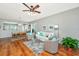 Open-concept living area connecting to the dining area, featuring hardwood floors and a ceiling fan at 106 Sea Lavender Ln, Summerville, SC 29486