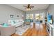 Inviting living room with wood floors, ceiling fan, neutral palette, and access to an outdoor screened patio at 106 Sea Lavender Ln, Summerville, SC 29486