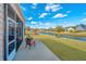 Outdoor patio with seating area overlooking a tranquil pond and community landscape at 106 Sea Lavender Ln, Summerville, SC 29486