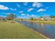 Scenic pond view showcasing community surroundings with lush greenery and well-maintained lawns at 106 Sea Lavender Ln, Summerville, SC 29486