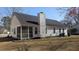 Rear exterior view featuring a screened-in porch and a spacious backyard at 107 Ranworth Ln, Summerville, SC 29485