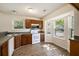 Charming kitchen featuring wooden cabinets, white appliances, hardwood floors and natural light at 107 Ranworth Ln, Summerville, SC 29485