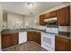 Charming kitchen featuring wooden cabinets, white appliances and hardwood floors at 107 Ranworth Ln, Summerville, SC 29485