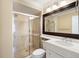 Bright bathroom featuring a glass shower door and a large framed mirror above the sink at 108 Smith St # 108-C, Charleston, SC 29403