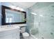 Updated bathroom features a modern shower, white vanity, large mirror, and marble accents at 108 Smith St # 108-C, Charleston, SC 29403