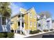 Charming yellow two-story home with double balconies and manicured landscaping, set under a clear blue sky at 108 Smith St # 108-C, Charleston, SC 29403