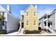A yellow two-story home with classic architecture, crisp white trim and manicured shrubbery at 108 Smith St # 108-C, Charleston, SC 29403