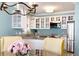 Bright kitchen with stainless steel appliances, granite countertops, and white cabinetry with glass fronts at 108 Smith St # 108-C, Charleston, SC 29403