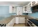 Modern kitchen featuring granite countertops, a wine rack, stainless steel appliances, and blue accent wall at 108 Smith St # 108-C, Charleston, SC 29403