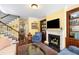 Bright living room with a fireplace, built-in shelving, hardwood floors and staircase at 108 Smith St # 108-C, Charleston, SC 29403