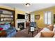 Living room with built-in bookshelves flanking a fireplace, hardwood floors, and bright lighting at 108 Smith St # 108-C, Charleston, SC 29403
