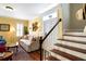 Sunlit living room features gleaming hardwood floors, soft lighting, and a view of the front door and staircase at 108 Smith St # 108-C, Charleston, SC 29403