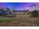 Wide backyard with a brick house, play equipment, and a large grassy area, perfect for outdoor activities at 110 Dunbury Dr, Summerville, SC 29485