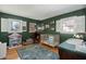 This Bedroom features green walls, hardwood floors, two windows, and a crib at 110 Dunbury Dr, Summerville, SC 29485
