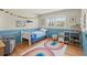Adorable bedroom with blue wainscoting, hardwood floors, and a cute rainbow rug at 110 Dunbury Dr, Summerville, SC 29485