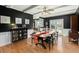 This beautiful dining room features dark walls, white trim, hardwood floors, and a unique wooden table at 110 Dunbury Dr, Summerville, SC 29485