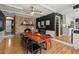This is a dining room with a brick fireplace, hardwood floors, and a large wooden table at 110 Dunbury Dr, Summerville, SC 29485
