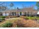 Well-maintained brick home featuring an attached garage, green door, and lush landscaping at 110 Dunbury Dr, Summerville, SC 29485