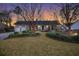 Beautiful one-story brick home with a manicured lawn and lush, landscaped garden at 110 Dunbury Dr, Summerville, SC 29485