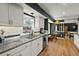 Bright kitchen featuring granite countertops, white cabinetry, stainless appliances, and an eat-in dining area at 110 Dunbury Dr, Summerville, SC 29485