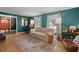 Bright living room with hardwood floors, teal walls, and natural light from large windows at 110 Dunbury Dr, Summerville, SC 29485