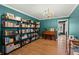 Well-lit living room featuring built in bookshelves, hardwood floors, a decorative chandelier, and natural light at 110 Dunbury Dr, Summerville, SC 29485