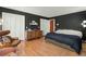The main bedroom features hardwood floors, dark accent wall, chair and ottoman, and closets at 110 Dunbury Dr, Summerville, SC 29485