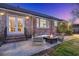 Cozy patio with a fire pit, surrounded by comfortable seating and a brick exterior, ideal for evening gatherings at 110 Dunbury Dr, Summerville, SC 29485