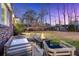 Outdoor patio with a fire pit, cozy seating, and a lush backyard view, perfect for relaxing evenings at 110 Dunbury Dr, Summerville, SC 29485