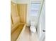 Bathroom featuring a toilet, bathtub and window at 112 Mansfield Blvd, North Charleston, SC 29418