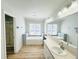 Bright bathroom featuring a soaking tub with tiled surround, a large vanity, and a separate shower at 112 Mansfield Blvd, North Charleston, SC 29418