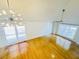 Bright living room featuring hardwood floors, modern chandelier, and large windows providing natural light at 112 Mansfield Blvd, North Charleston, SC 29418