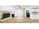 Open-concept area with fireplace, sliding doors, and modern kitchen with black appliances at 112 Mansfield Blvd, North Charleston, SC 29418