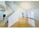 Bright living room featuring hardwood floors, modern chandelier, and staircase access at 112 Mansfield Blvd, North Charleston, SC 29418