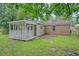 Backyard view featuring a screened-in porch with siding and brick details at 112 Pine Grove Dr, North Charleston, SC 29420