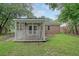 View of a screened-in porch and backyard showcasing a mix of siding and brick at 112 Pine Grove Dr, North Charleston, SC 29420