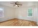 Airy bedroom with wood floors and two windows allowing ample natural light in the space at 112 Pine Grove Dr, North Charleston, SC 29420