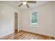 Bright bedroom with a ceiling fan, a closet, hardwood floors, and a window offering a peaceful view at 112 Pine Grove Dr, North Charleston, SC 29420