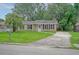 Traditional home with brick facade, black shutters, and a concrete driveway at 112 Pine Grove Dr, North Charleston, SC 29420