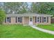 Inviting brick home with manicured lawn and walkway leading to the front door at 112 Pine Grove Dr, North Charleston, SC 29420
