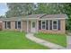 Charming brick home with a well-maintained lawn and black shutters at 112 Pine Grove Dr, North Charleston, SC 29420