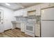 Kitchen featuring a decorative backsplash, white cabinets, and modern appliances at 112 Pine Grove Dr, North Charleston, SC 29420