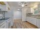 Kitchen featuring a decorative backsplash, white cabinets, and modern appliances at 112 Pine Grove Dr, North Charleston, SC 29420