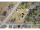 Aerial shot featuring a house with a verdant lawn in a serene, tree-lined neighborhood at 1186 French Santee Rd, Jamestown, SC 29453